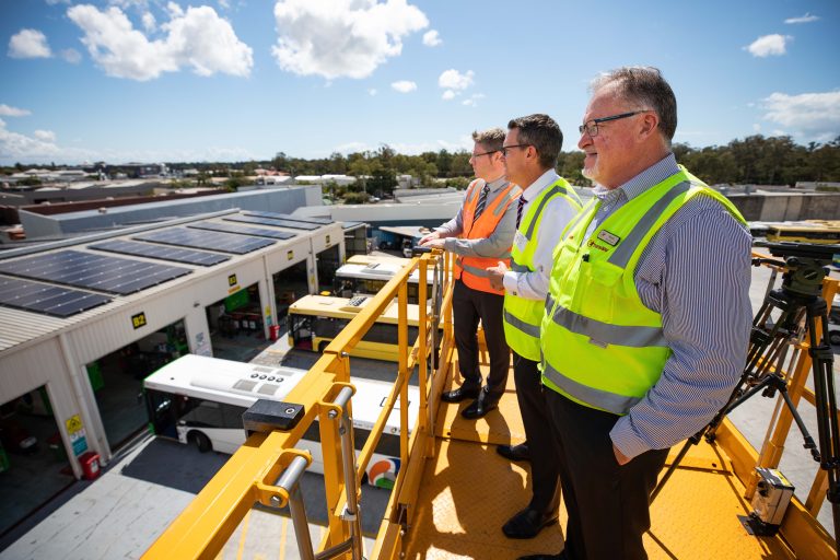 Transdev Australasia Head of Engineering Marc Cleave, TransLink CEO Matt Longland, Transdev Queensland Head of Business Operations Mark McKenzie looking at solar panel installation at Transdev’s Capalaba Depot, Brisbane