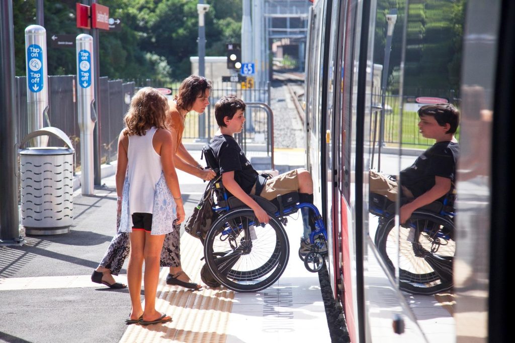 Image of customer in wheelchair boarding Sydney Light Rail service