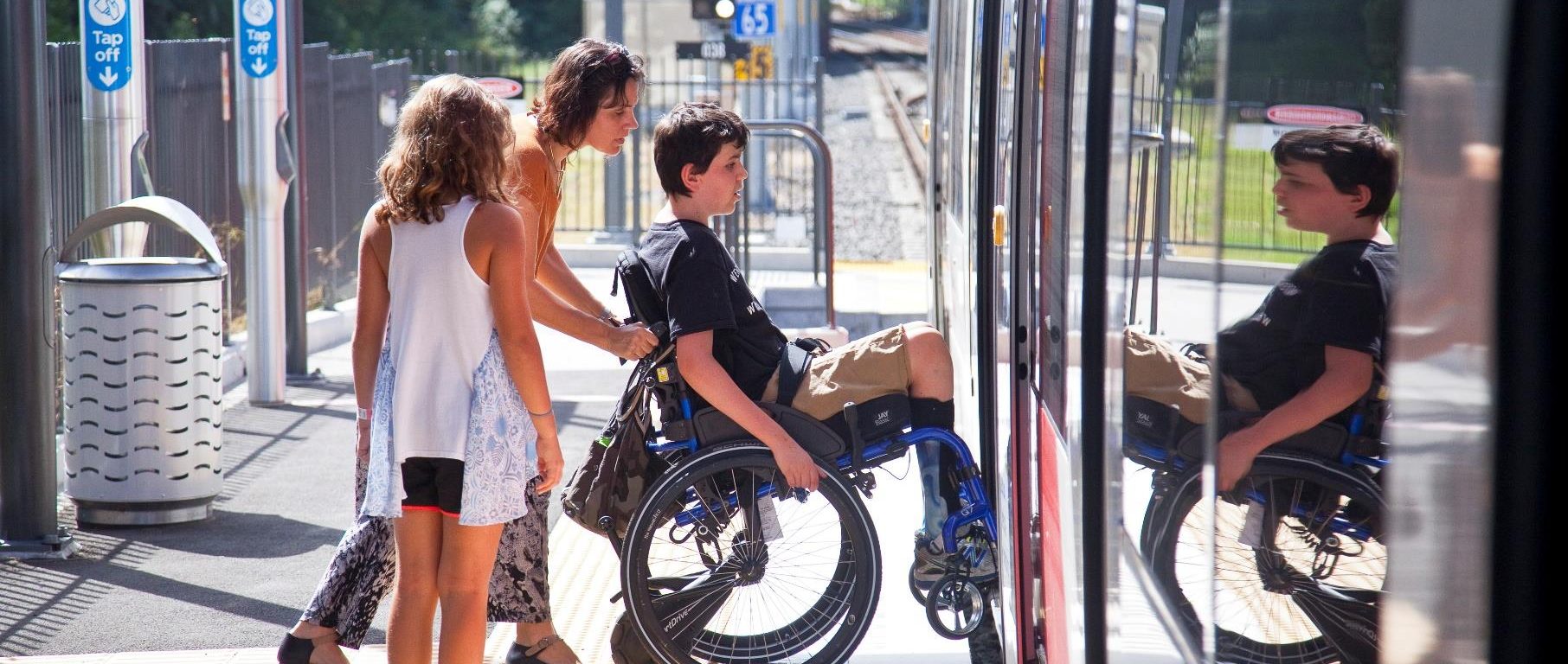 Image of customer in wheelchair boarding Sydney Light Rail service