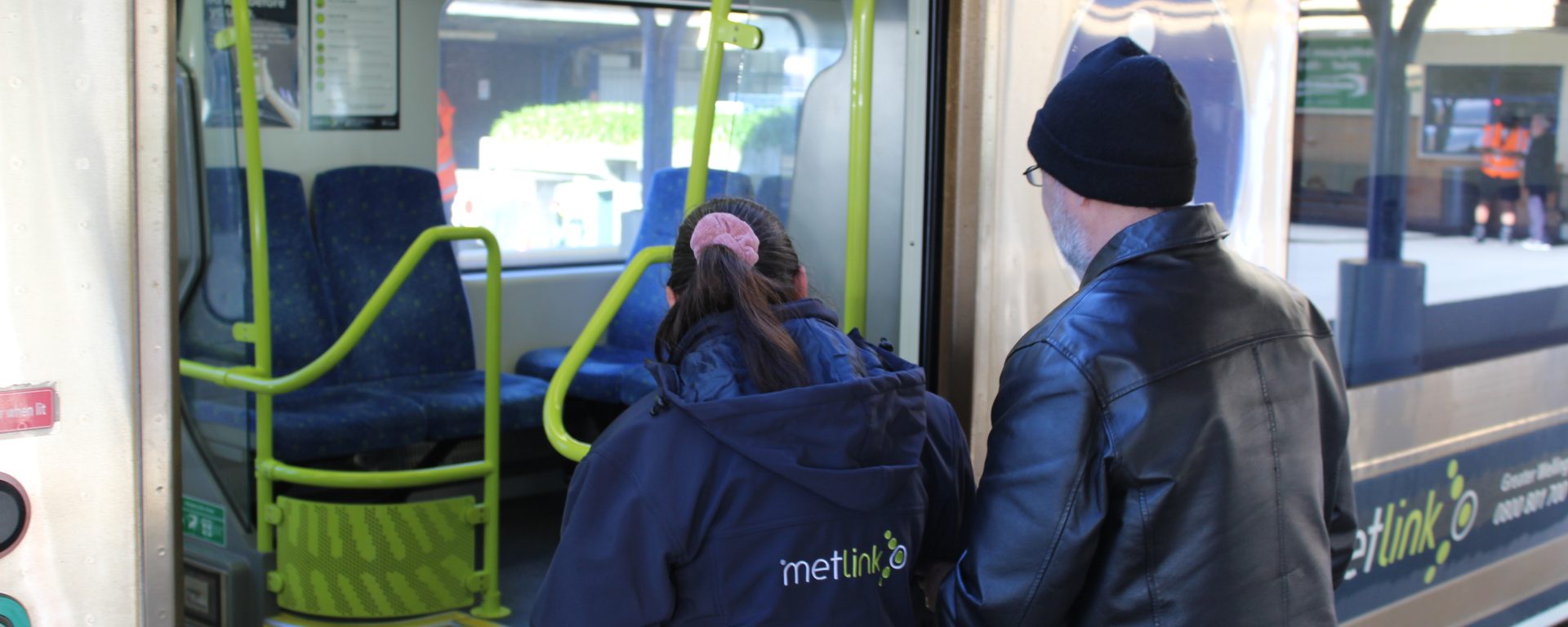 Image of Wellington rail employee assisting passenger to board