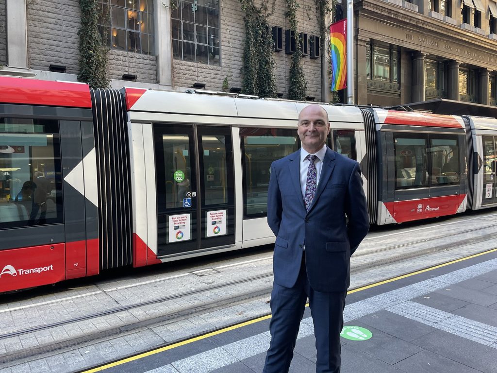 Huw Bridges, Chief Safety and Assurance Officer, pictured in front of Light Rail vehicle
