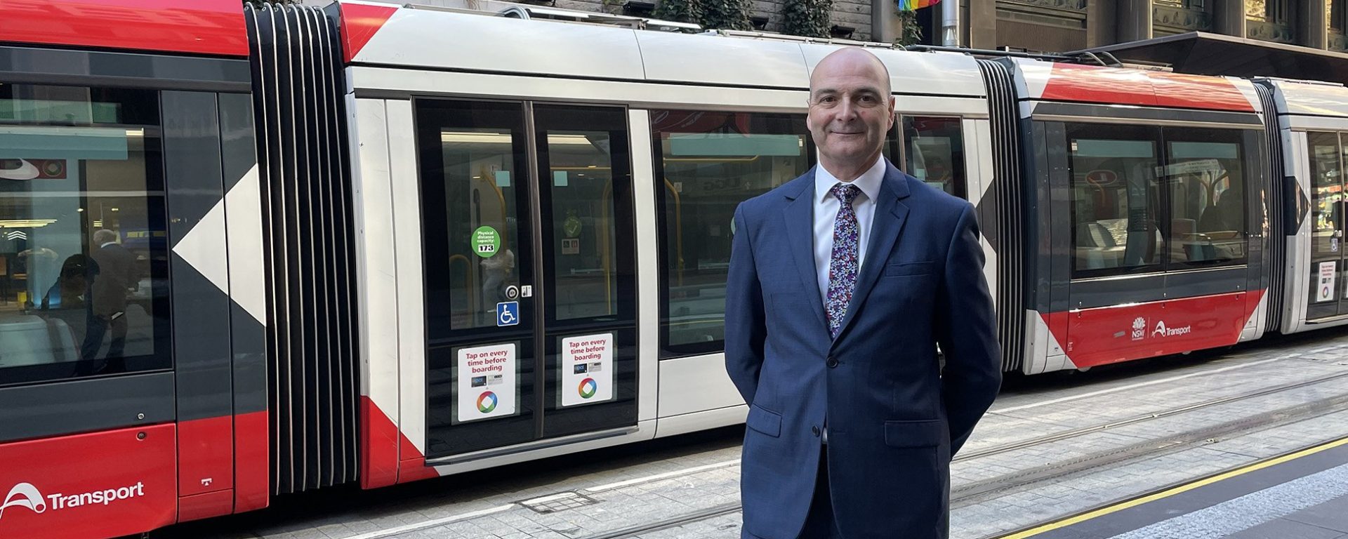 Huw Bridges, Chief Safety and Assurance Officer, pictured in front of Light Rail vehicle