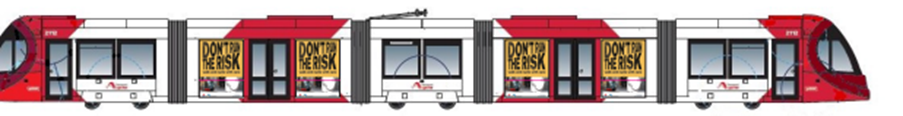 A mock up of the 'Don't Run the Risk' Safety Campaign as it will appear on Sydney Light Rail carriages. The illustration of the light rail, alongside it's usual red regalia, features black and yellow signage advising pedestrians to ensure they observe safe behaviour around the light rail.