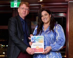 A woman receiving an award.